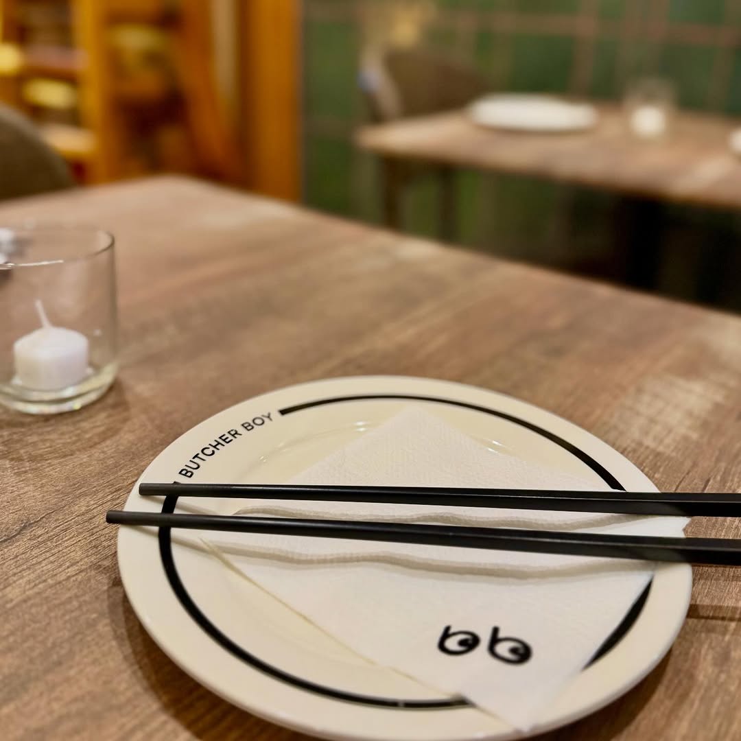 Butcher Boy interior with bb branded plate and chopsticks
